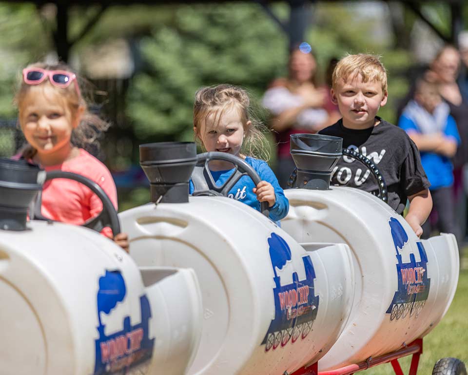 Kids riding on the train at Woodchip Campground