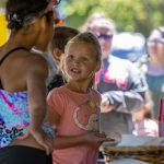 Children and families enjoying a summer activity at Woodchip Campground in Michigan