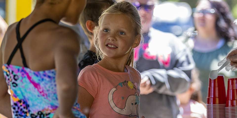 Children and families enjoying a summer activity at Woodchip Campground in Michigan