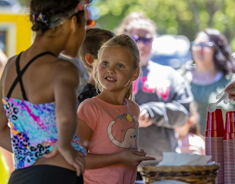 Children and families enjoying a summer activity at Woodchip Campground in Michigan