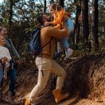 Family hiking a wooded trail during a spring adventure near Grand Rapids, Michigan